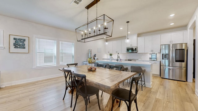 dining space with visible vents, recessed lighting, light wood-type flooring, and baseboards