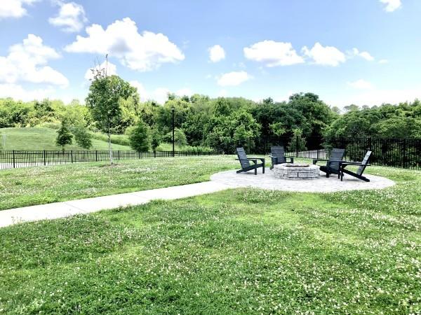 view of yard with a patio area, fence, and an outdoor fire pit