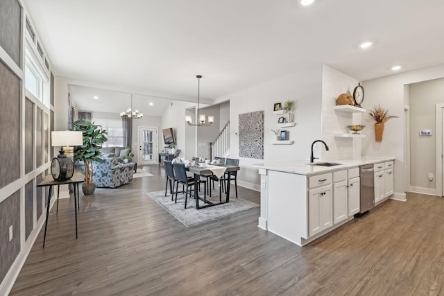 kitchen with open shelves, plenty of natural light, a sink, white cabinetry, and a notable chandelier