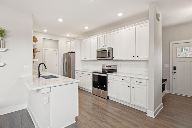 kitchen featuring a sink, dark wood-style floors, white cabinetry, and stainless steel appliances