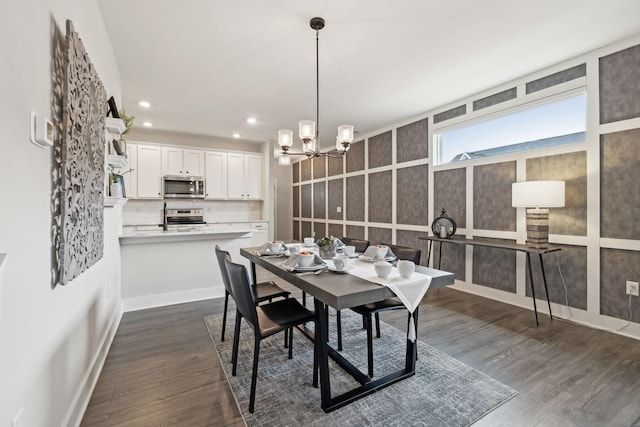 dining area featuring dark wood-style floors, recessed lighting, baseboards, and an inviting chandelier