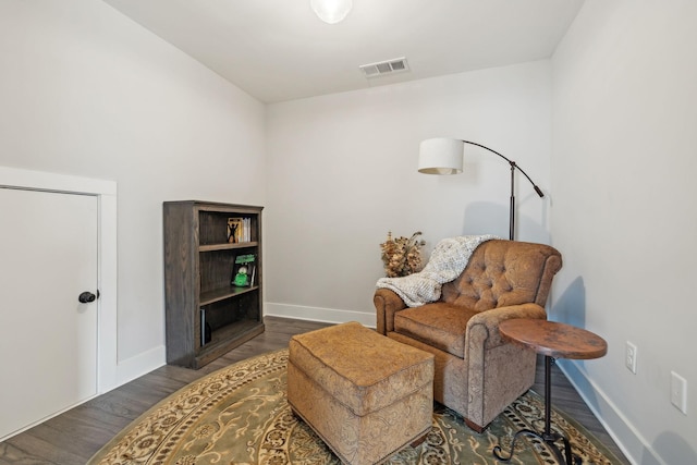 sitting room featuring visible vents, baseboards, and wood finished floors