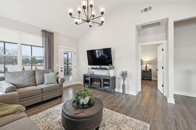 living room featuring dark wood-style floors, visible vents, and high vaulted ceiling