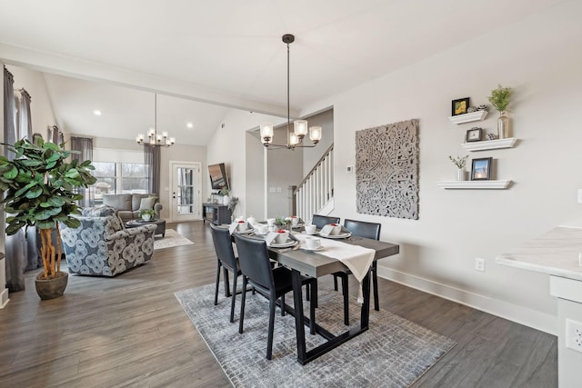 dining space featuring stairway, a notable chandelier, wood finished floors, and baseboards