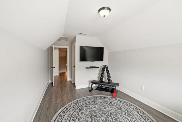 workout room featuring lofted ceiling, wood finished floors, visible vents, and baseboards