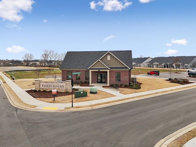 craftsman house featuring a residential view, brick siding, and board and batten siding