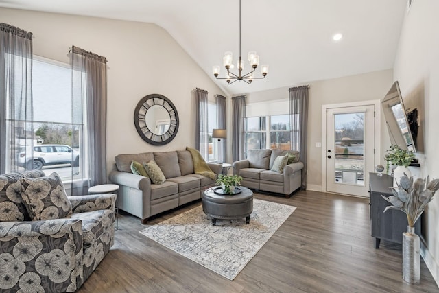 living area with lofted ceiling, plenty of natural light, an inviting chandelier, and dark wood-style flooring