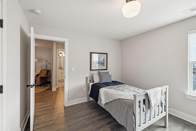 bedroom featuring dark wood-style floors, visible vents, and baseboards