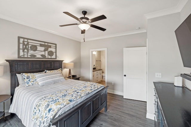 bedroom featuring ensuite bath, dark wood-style floors, crown molding, baseboards, and ceiling fan