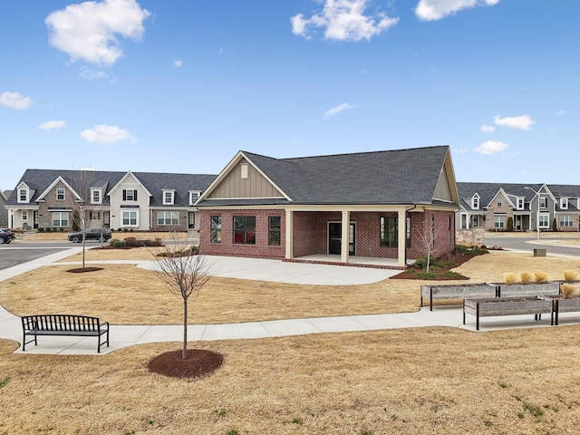 exterior space with brick siding, a residential view, and board and batten siding