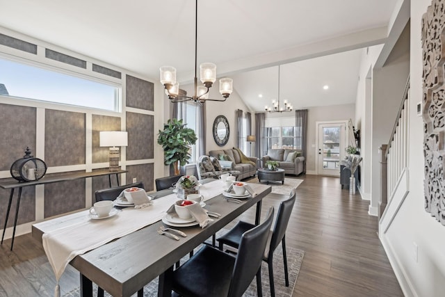 dining space featuring dark wood finished floors, lofted ceiling with beams, stairs, and an inviting chandelier