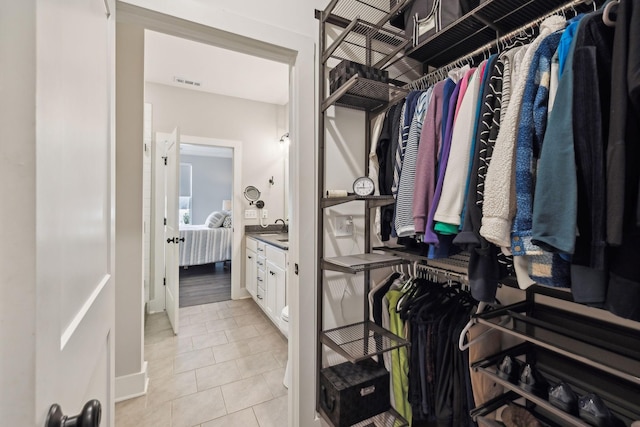 walk in closet featuring light tile patterned floors and visible vents