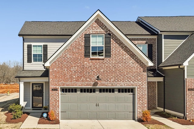 view of front of home with concrete driveway, a garage, brick siding, and roof with shingles