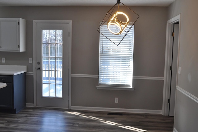 entryway featuring baseboards and dark wood-style flooring