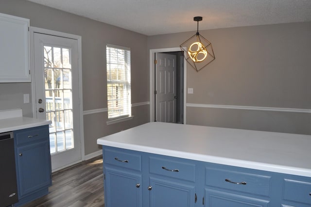 kitchen featuring blue cabinets, dishwasher, dark wood finished floors, and light countertops