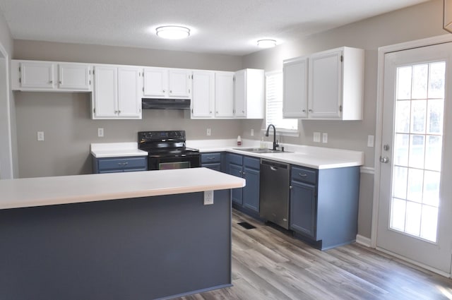 kitchen with a sink, black electric range, white cabinets, stainless steel dishwasher, and blue cabinets