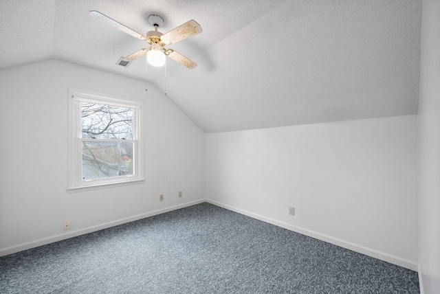 bonus room with baseboards, ceiling fan, vaulted ceiling, carpet flooring, and a textured ceiling