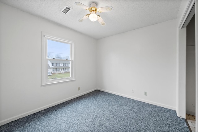 unfurnished bedroom featuring visible vents, baseboards, ceiling fan, carpet, and a textured ceiling