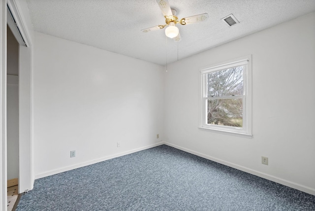 unfurnished room featuring a ceiling fan, baseboards, visible vents, a textured ceiling, and carpet flooring