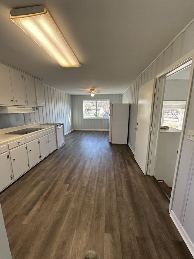 kitchen with white appliances, dark wood-style flooring, ceiling fan, light countertops, and white cabinetry