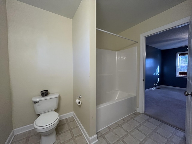 full bathroom with tile patterned floors, toilet, baseboards, and shower / bath combination