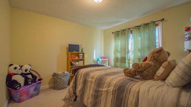 carpeted bedroom with baseboards