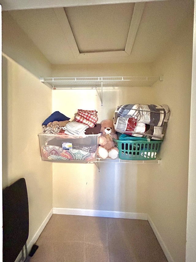 walk in closet featuring attic access