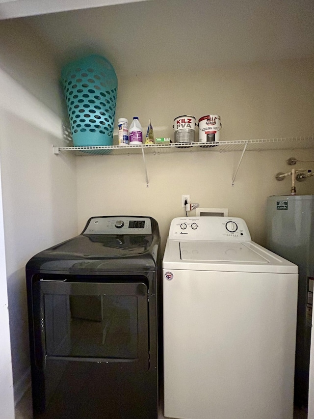 laundry area featuring independent washer and dryer, water heater, and laundry area