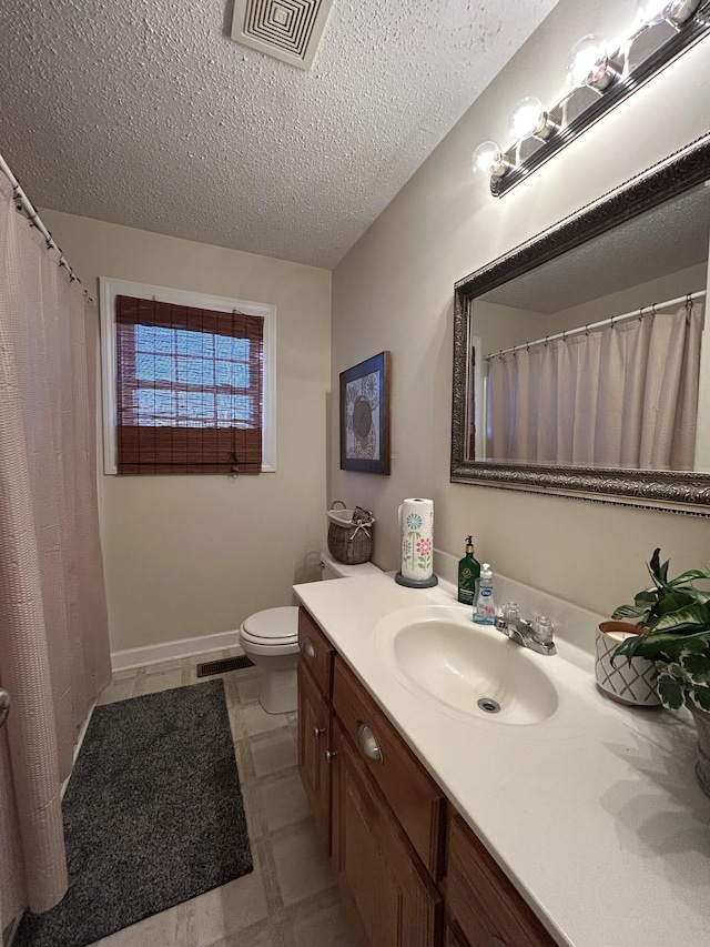 full bathroom with visible vents, a textured ceiling, vanity, and toilet