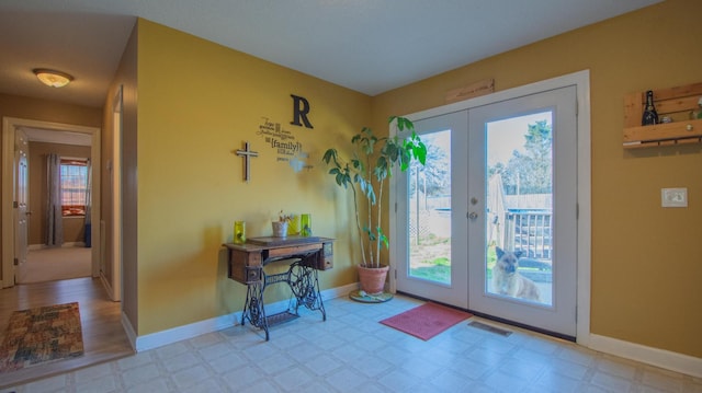 doorway to outside featuring tile patterned floors, french doors, visible vents, and a healthy amount of sunlight