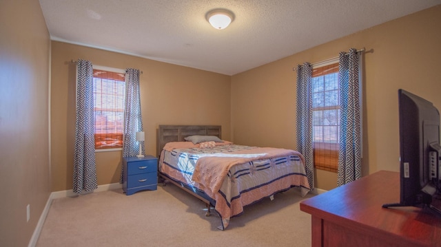 bedroom with a textured ceiling, baseboards, and light carpet