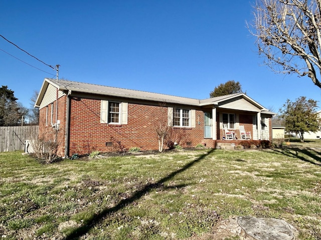 ranch-style home with a front lawn, a porch, fence, crawl space, and brick siding