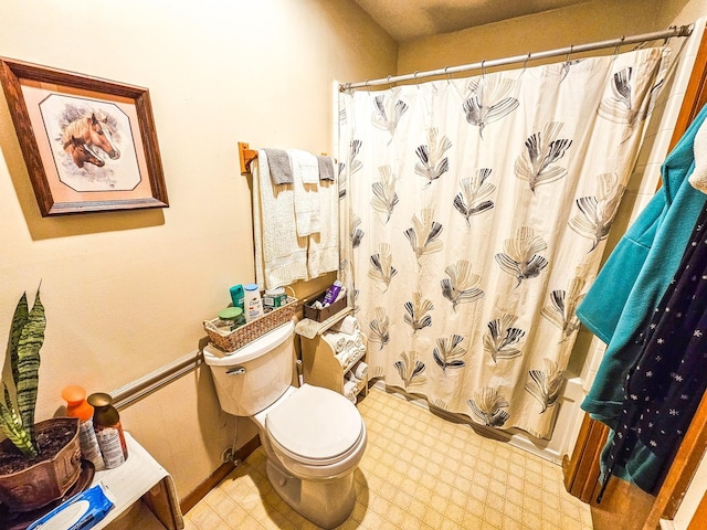 full bathroom with tile patterned floors, toilet, and a shower with shower curtain