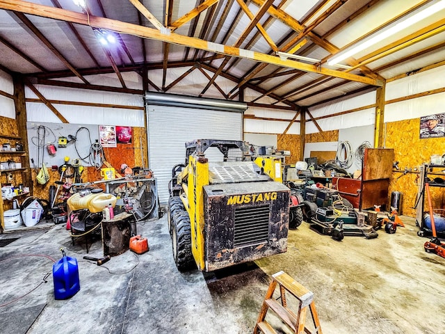 garage featuring a workshop area and metal wall