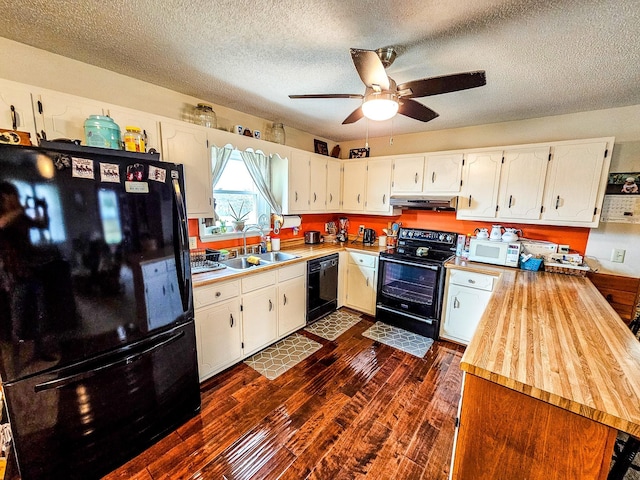 kitchen featuring dark wood-style flooring, a sink, black appliances, white cabinets, and under cabinet range hood