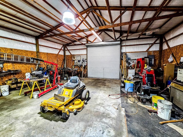 garage featuring a workshop area and metal wall