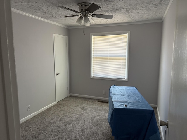 interior space with baseboards, a textured ceiling, crown molding, and ceiling fan