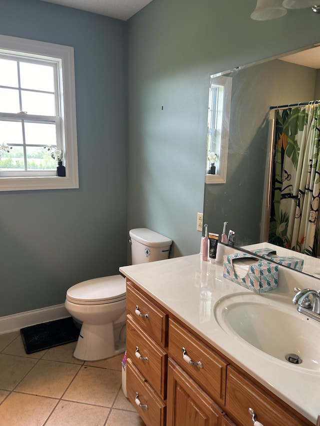 bathroom featuring vanity, a shower with shower curtain, baseboards, tile patterned flooring, and toilet