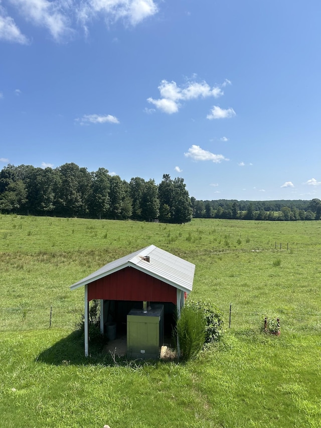 view of shed with a rural view