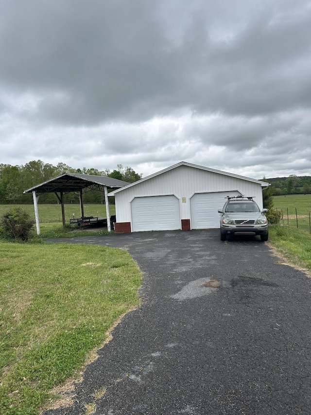 view of property exterior featuring a detached garage, a yard, and an outbuilding