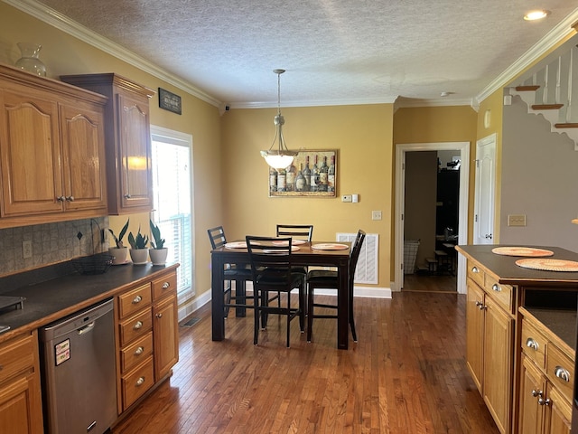 kitchen featuring dark countertops, dark wood-style floors, and stainless steel dishwasher