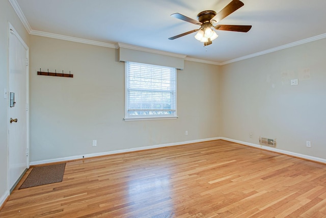 empty room with visible vents, crown molding, baseboards, ceiling fan, and light wood-style flooring