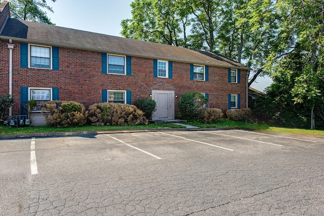 view of front of property featuring uncovered parking and brick siding