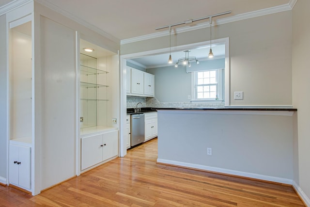 kitchen featuring light wood-style flooring, a sink, white cabinets, crown molding, and dishwasher