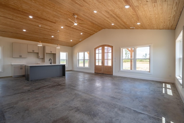241 Springer, Hohenwald, TN 38462 - unfurnished living room featuring wood ceiling, concrete flooring, lofted ceiling, baseboards, and recessed lighting