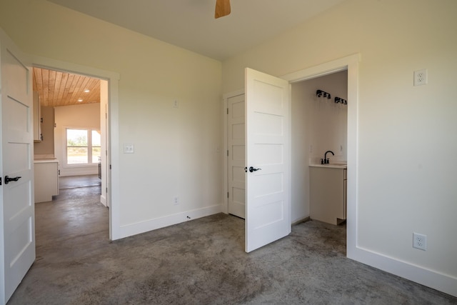 241 Springer, Hohenwald, TN 38462 - unfurnished bedroom with a sink, lofted ceiling, and baseboards