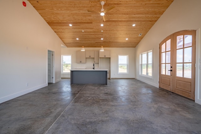 241 Springer, Hohenwald, TN 38462 - unfurnished living room featuring wooden ceiling, baseboards, finished concrete flooring, french doors, and high vaulted ceiling
