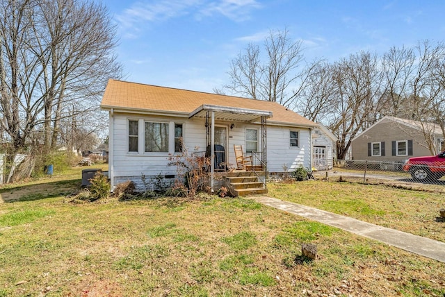 bungalow-style house with crawl space, a front lawn, and fence