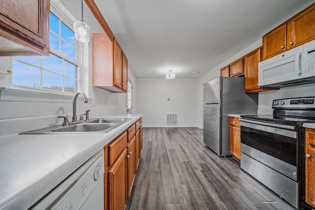 131 Dalton Cir, Rockvale, TN 37153 - kitchen featuring visible vents, brown cabinets, appliances with stainless steel finishes, dark wood-style floors, and a sink
