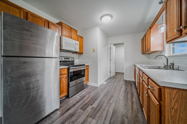 131 Dalton Cir, Rockvale, TN 37153 - kitchen with a sink, appliances with stainless steel finishes, brown cabinetry, light countertops, and baseboards